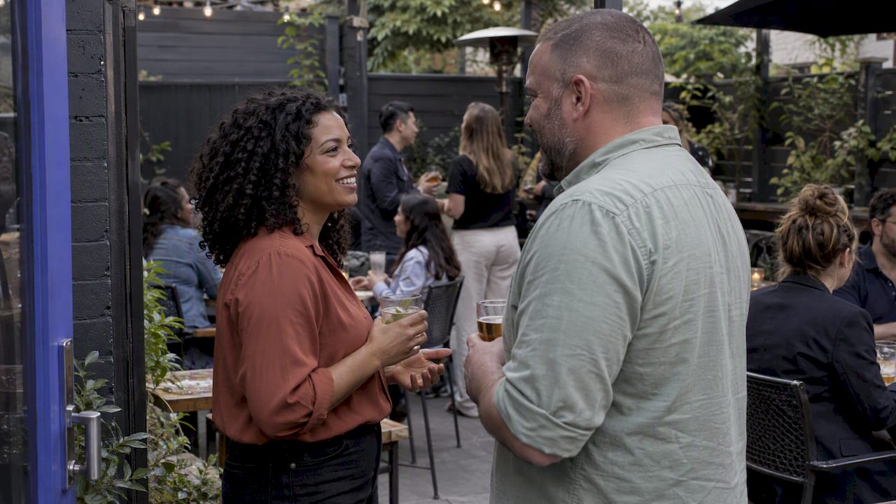 Guests gathering at a neighborhood patio happy hour